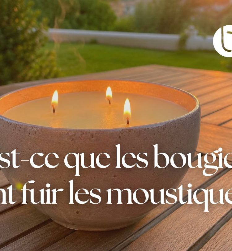 Bougie anti-moustique allumée sur une table en bois en extérieur pendant une soirée d’été